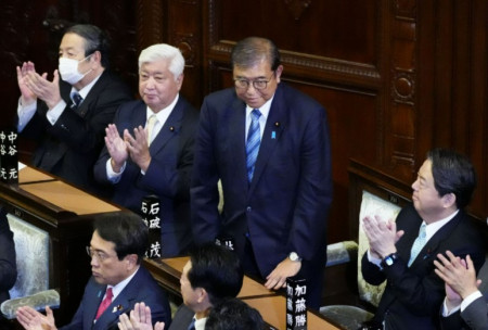 Japan’s PM retains post, though shares power